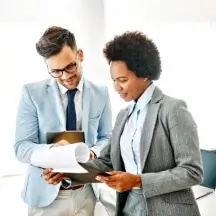 Colleagues reviewing printed documents.