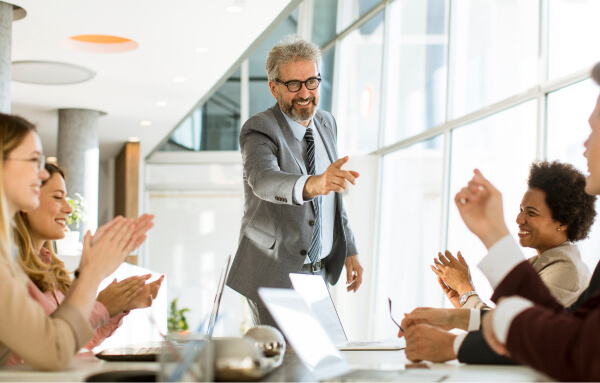 leader applauded during team meeting