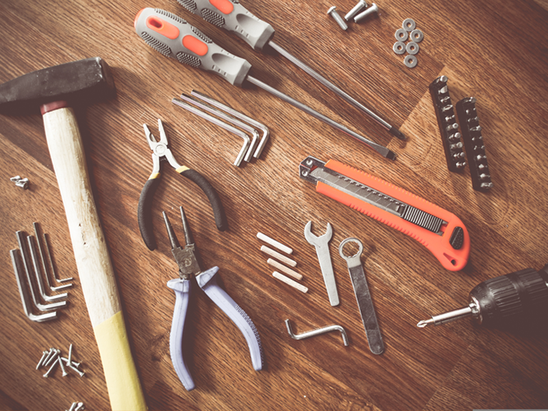 assorted hand tools on table