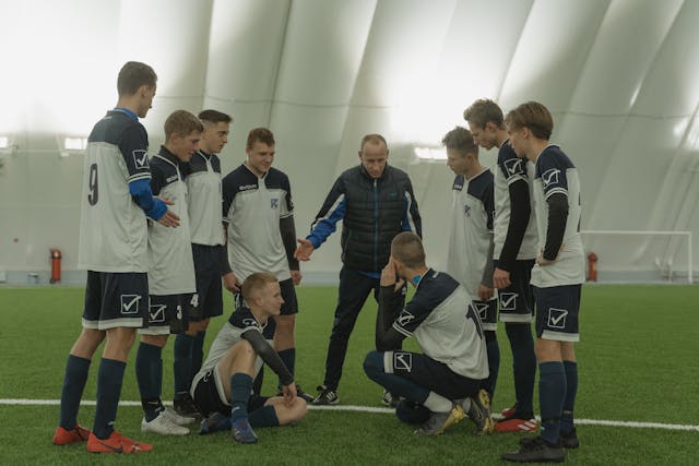 coach motivates youth football team